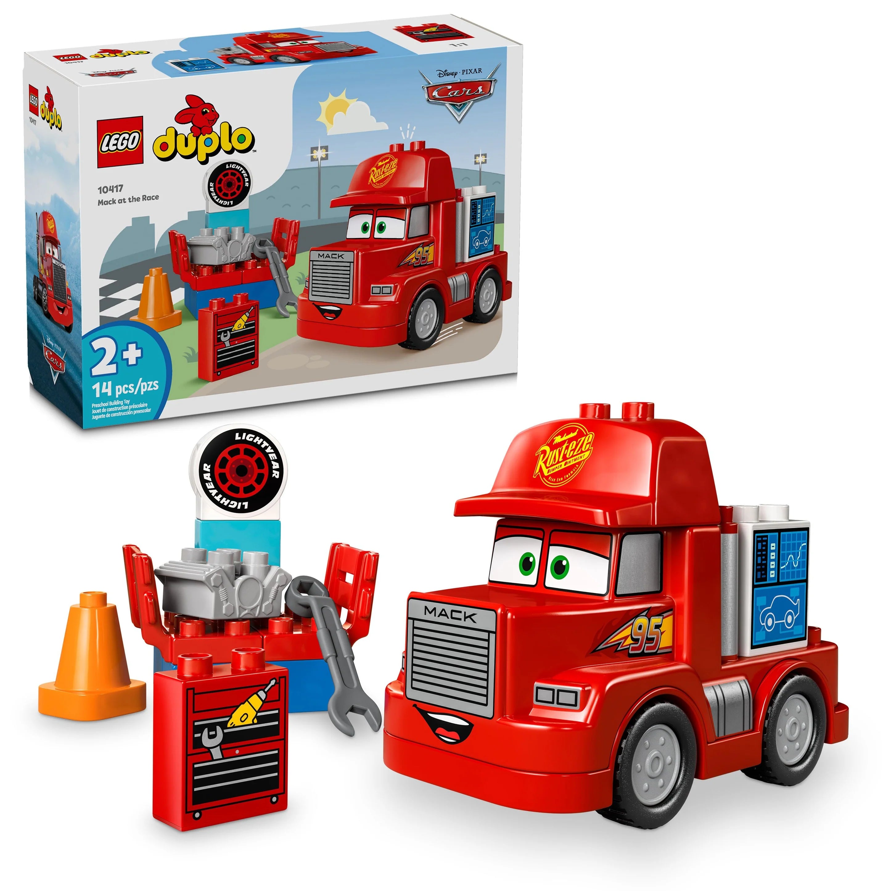 LEGO DUPLO set featuring Disney and Pixar's Cars character Mack at the Race. Includes a red Mack truck with details, a garage playset, a computer, wrench, spare engine, and other play accessories.
