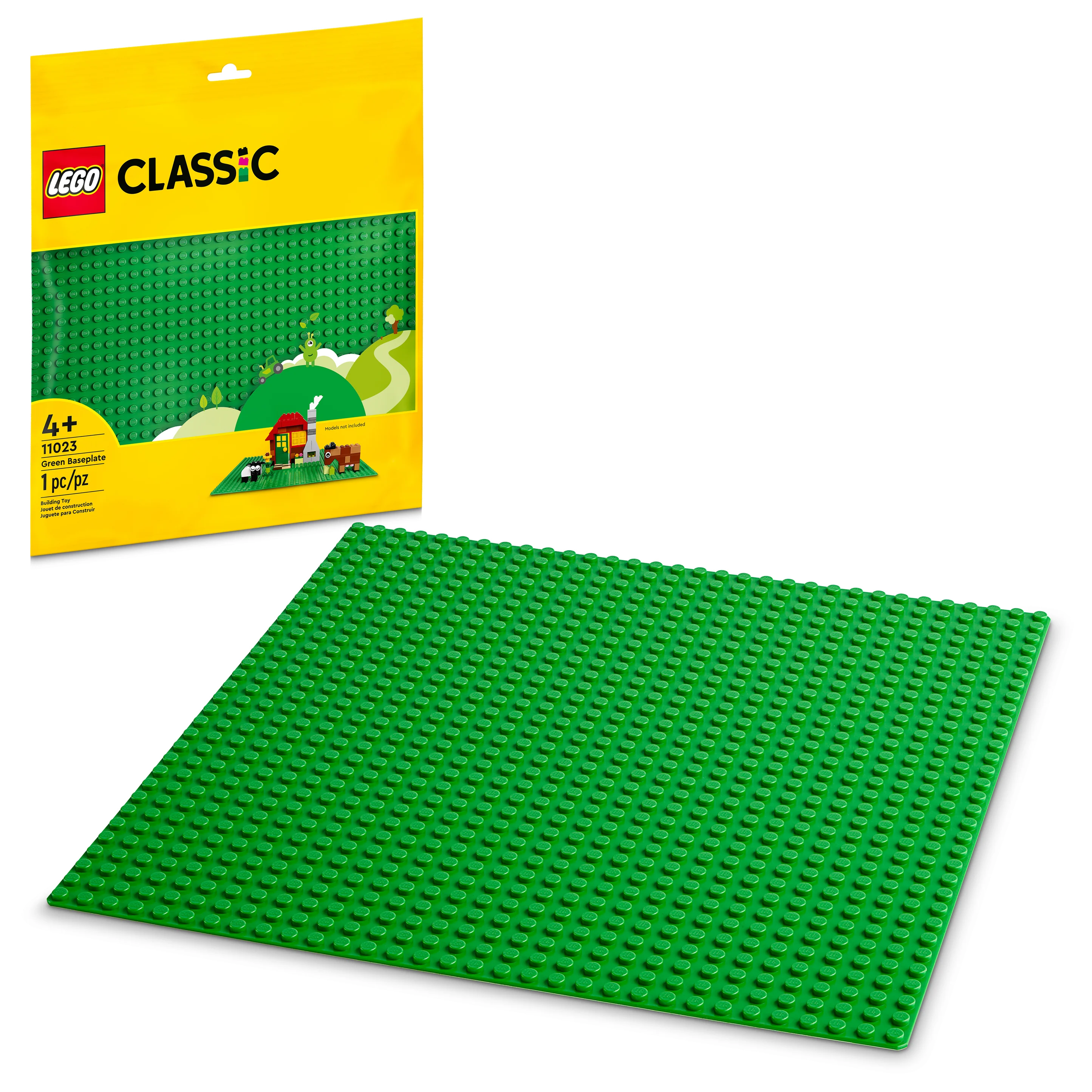 A green LEGO baseplate number 11023 from the Classic line, displayed alongside its packaging.